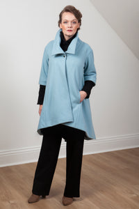 Woman wearing the Grace coat in icy blue wool - front view