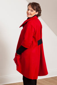 Woman wearing the Grace coat in red wool - side view