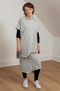 woman wearing a grey asymmetrical tunic with accent pocket - front view 